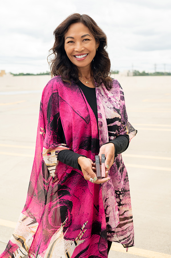 Anna is wearing a combination of 'Stormy' and 'Promise' Lipsticks with a vibrant Wrapped in Love pink kimono