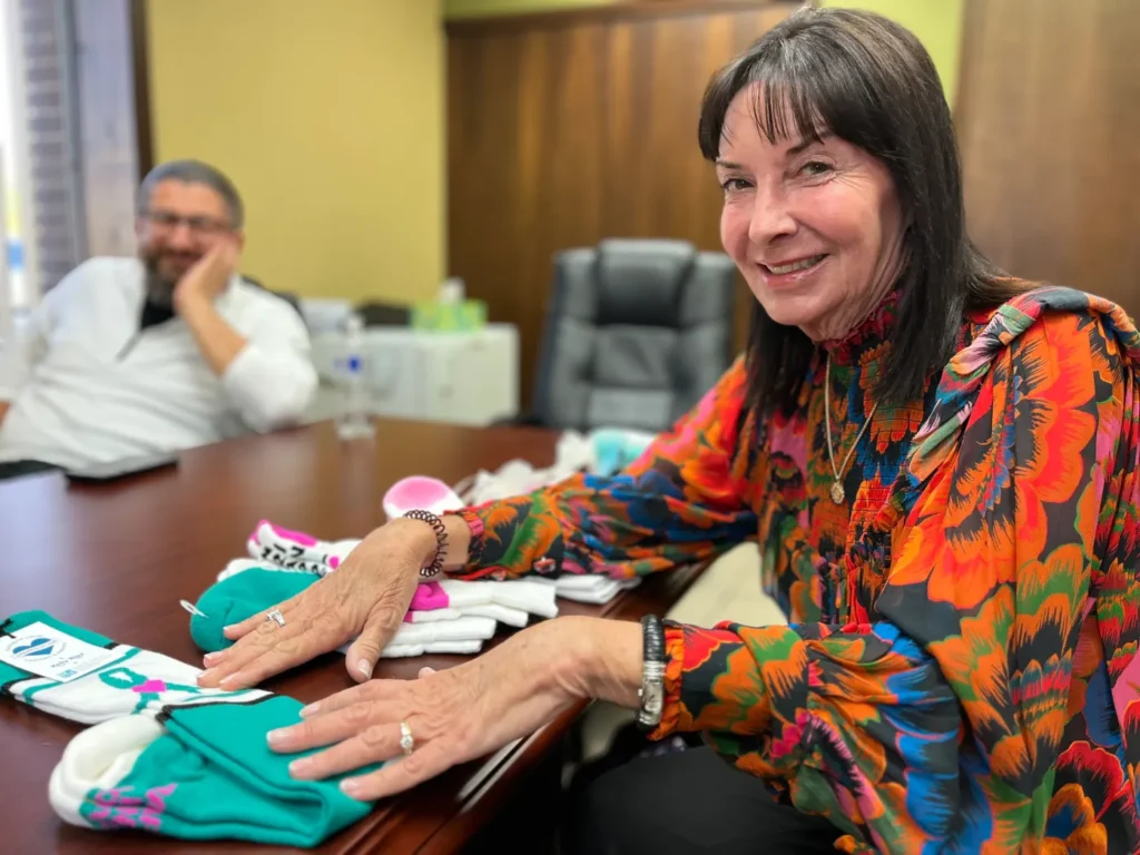 Karen MacDonald of Sterling Heights displays some of the socks created by the Soyad Brothers Textile Corporation for Wrapped in Love, a business that provides comfy and stylish clothing for cancer patients, a business inspired by a wrap MacDonald made to comfort her ailing mother.